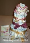 sugar and spice diaper cake with purple and gold ribbon