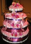 elegant hawaiian diaper cake with pink and purple ribbon and hawaiian flowers