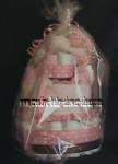 pink and white polka dot diaper cake with brown ribbon