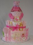 pink bat diaper cake with lots of pink baby items