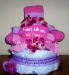 pink and purple girl diaper cake with a cute onesie that says I can't talk yet but I have attitued