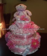 pink daisy polka dot diaper cake with pink and white paper shred