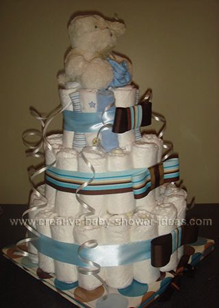 side of bear diaper cake with washcloth roses and bows