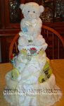 cream bear diaper cake with baby on board sign