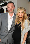 pregnant nicole richie wearing black dress standing next to husband