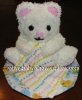 white teddy bear cake with colorful blanket