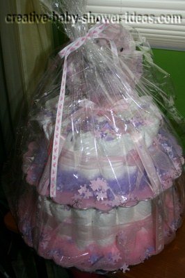 pink and purple teddy bear girl diaper cake wrapped in cellophane