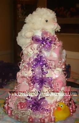 white lamb diaper cake with purple bows