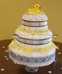 yellow duck diaper cake with blue and brown ribbon decorations