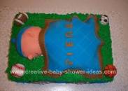 sleeping baby soccer cake with green grass and blue and brown blanket