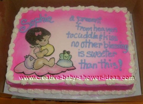 pink baby shower cake with picture of baby sitting on a blanket next to a smiling frog 