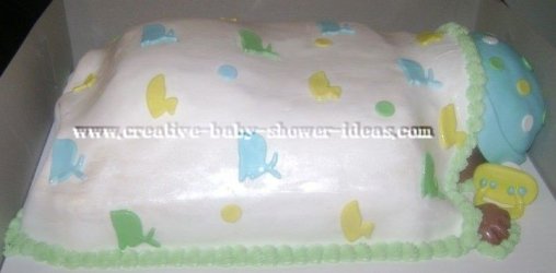 side of sleeping baby cake showing cute hand and pacifier