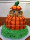 cute baby peeking out of a pumpkin baby shower cake