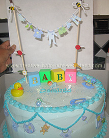 closeup of baby blocks and clothesline on cake