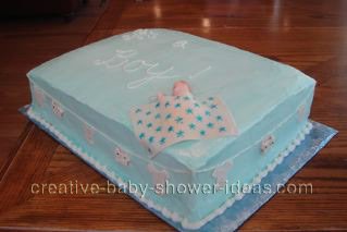 top of blue quilt cake with sleeping baby