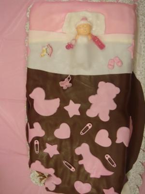 baby sleeping on pink and brown baby shower cake