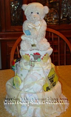 cream bear and blankets diaper cake with baby on board sign