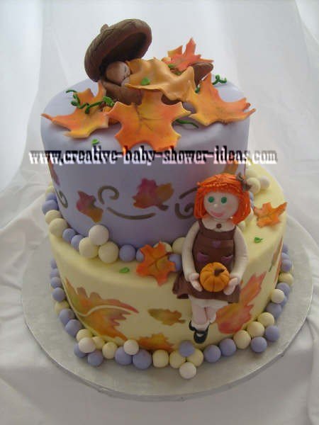 fall leaf baby shower cake with baby sleeping in acorns on top