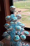 cupcake stand with white cupcakes and blue sprikles