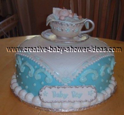 royal tea party cake with blue pillow white hankerchief and elegant edible tea cup on top